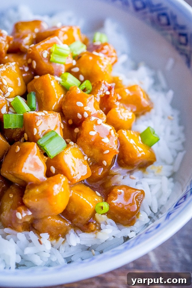 Zesty Vegan Orange Tofu 5 A close-up shot of individual vegan orange tofu pieces, showing their crispy texture and glossy sauce coating