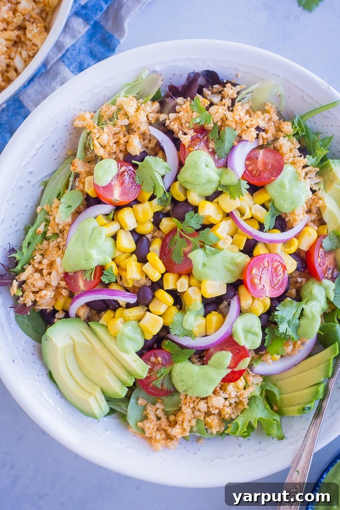 Creamy Avocado Ranch 5 Avocado ranch dressing generously drizzled over a colorful burrito bowl, enhancing its visual appeal and flavor.
