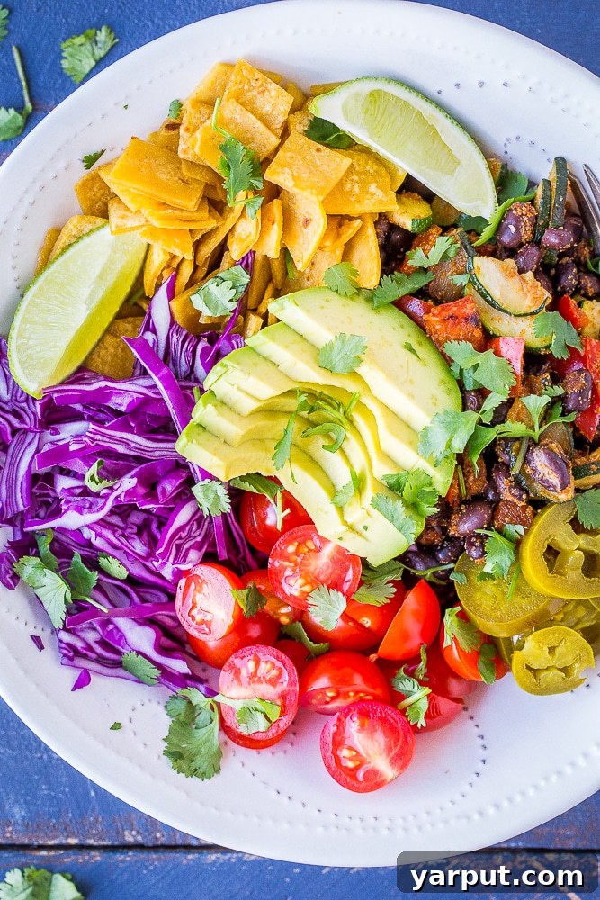 Vibrant Vegan Taco Power Bowls 5 A close-up view of two fully assembled Vegan Taco Bowls, rich with colorful toppings and perfectly showcasing the inviting textures and fresh ingredients.