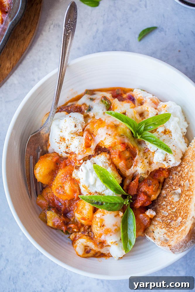 30-Minute Skillet Gnocchi Lasagna 4 Gnocchi Lasagna Bake in a bowl with fresh basil and crusty bread