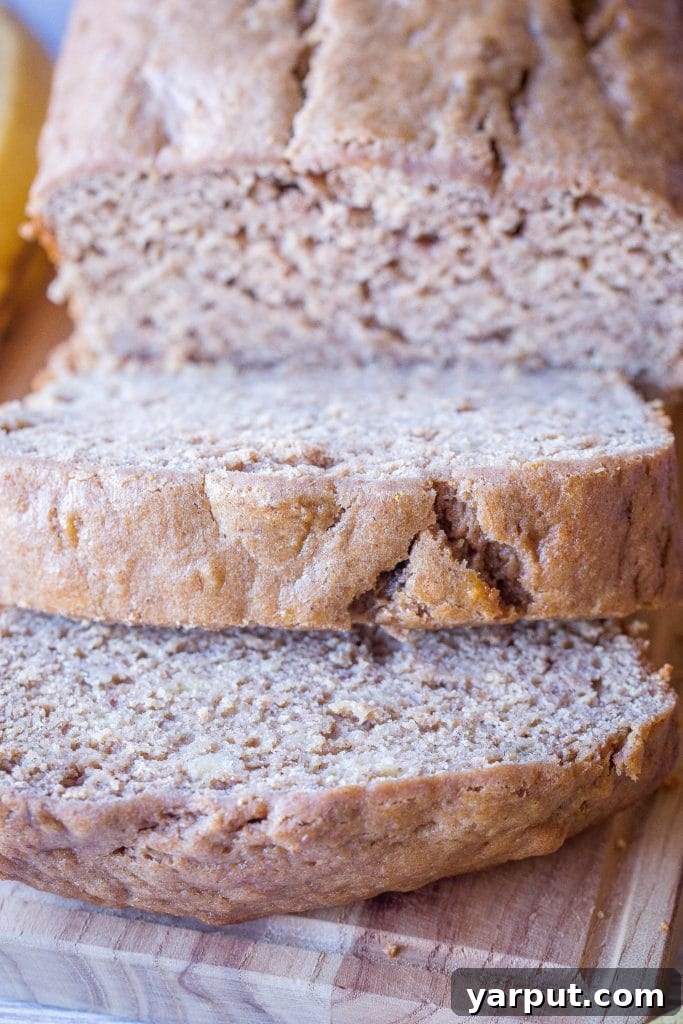 Naturally Sweet Effortless Banana Bread 4 Close up view of a slice of healthy banana bread, showing its moist crumb and specks of banana