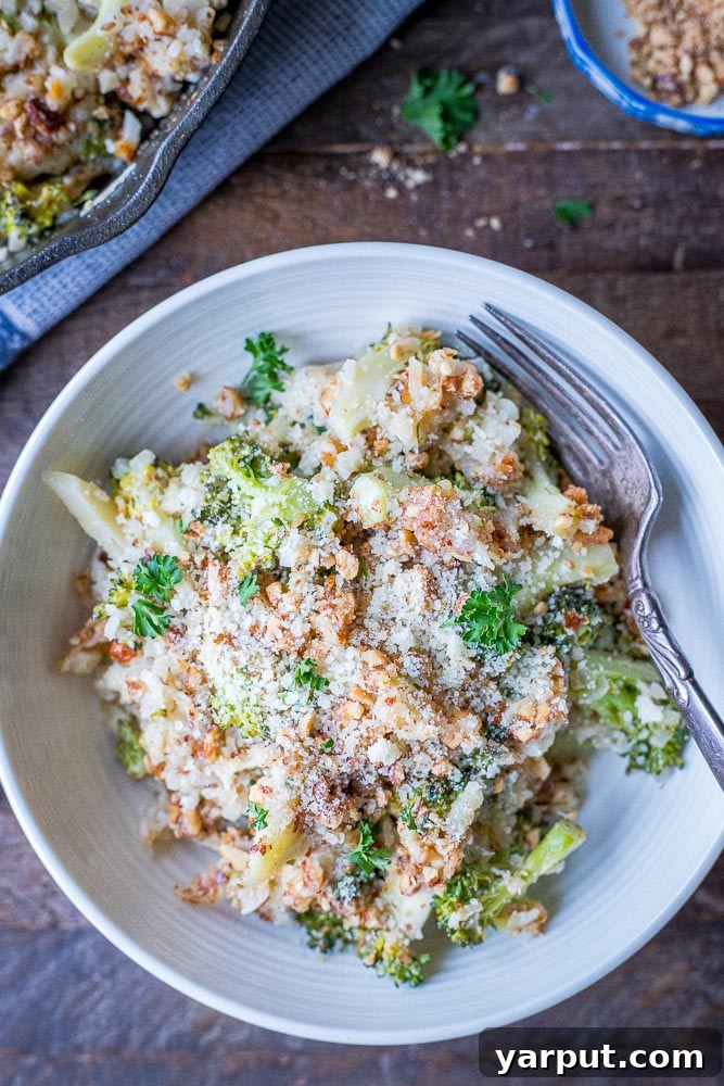 A cozy bowl of low-carb keto broccoli cheese casserole on a rustic wooden table, ready to be enjoyed.