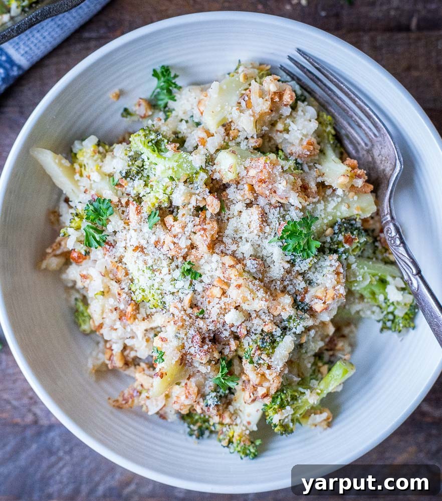 A close-up shot of a single serving of the cheesy broccoli casserole, showing its creamy texture and golden topping.