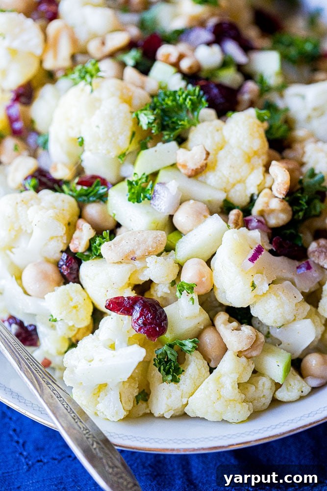 Golden Curried Cauliflower Salad 6 Close up of curried cauliflower salad, highlighting the texture of the cauliflower and other ingredients.