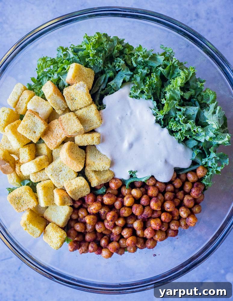 Caesar Kale Pita Pockets 4 A large, inviting bowl filled with the colorful and fresh ingredients for Kale Caesar Salad Pitas, ready to be mixed and served.