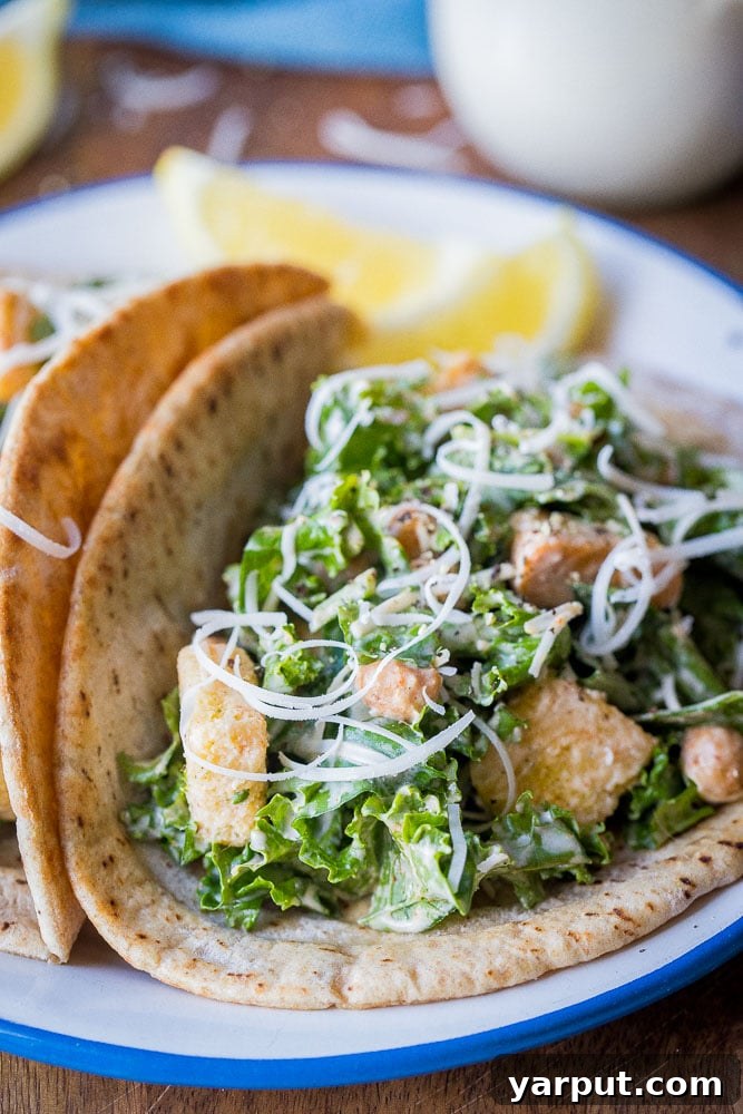Caesar Kale Pita Pockets 5 Close up shot of multiple Kale Caesar Salad Pitas, showcasing their appealing presentation and delicious filling, ready to be enjoyed.