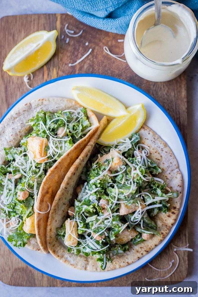 Caesar Kale Pita Pockets 6 Flat lay view of a plate featuring two perfectly assembled Kale Caesar Salad Pitas, garnished and ready for a delicious meal.