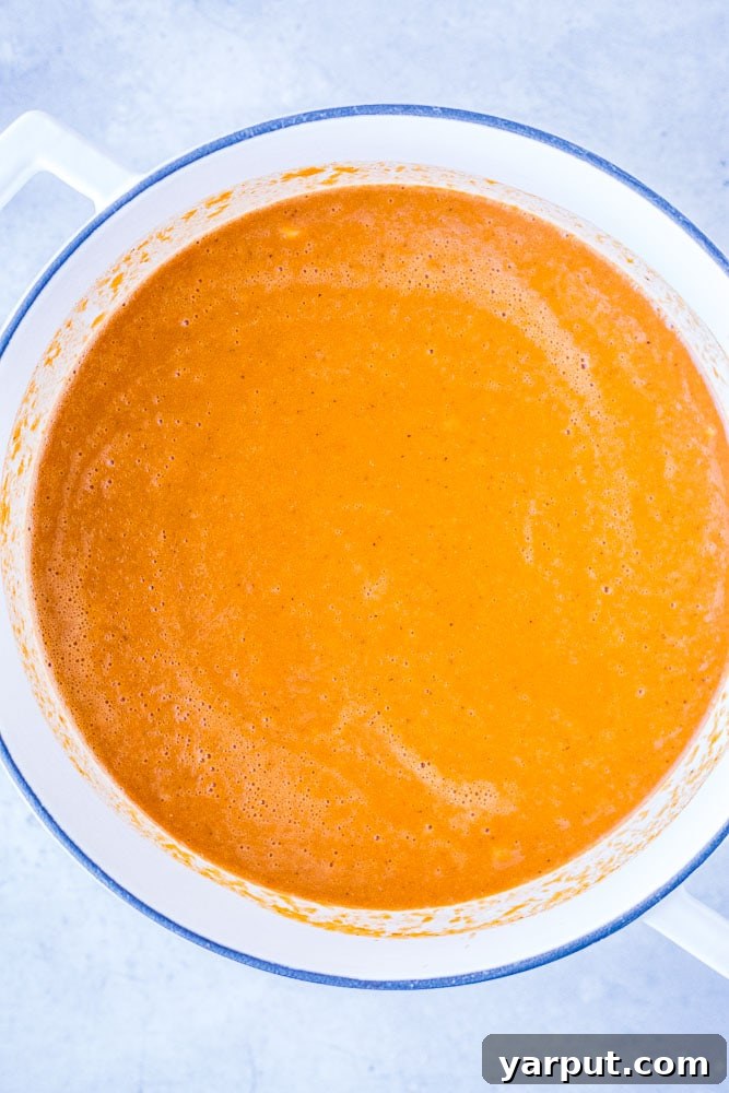 Vibrant Veggie Tortilla Soup 5 A large pot brimming with rich, homemade vegetarian tortilla soup, ready to be served or blended for a creamy texture, showcasing its vibrant color and hearty ingredients.