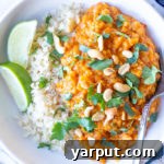 Red Lentil Curry in a bowl, garnished with fresh herbs
