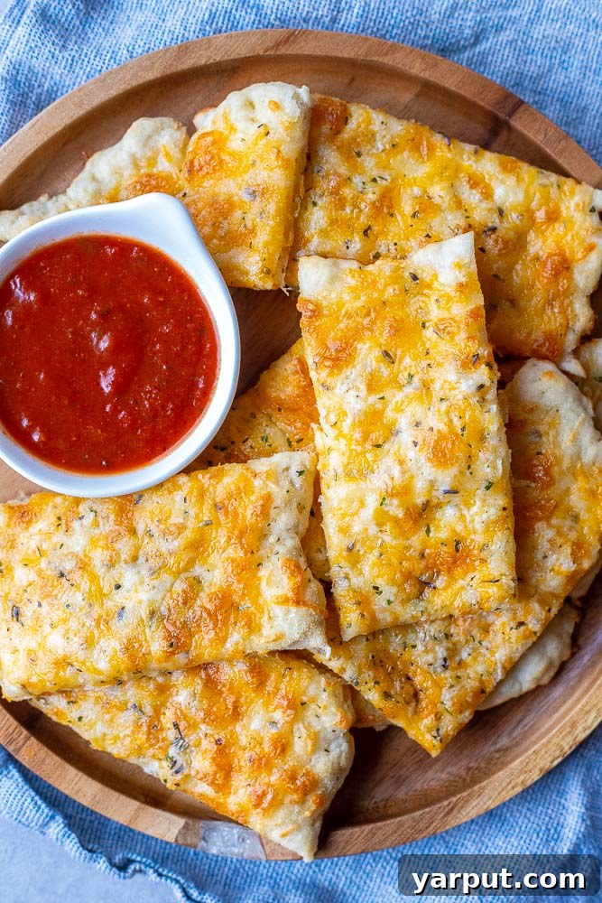 Effortless Garlic Cheese Bread 2 A plate of freshly cut garlic cheese bread, golden brown and bubbly with melted cheese