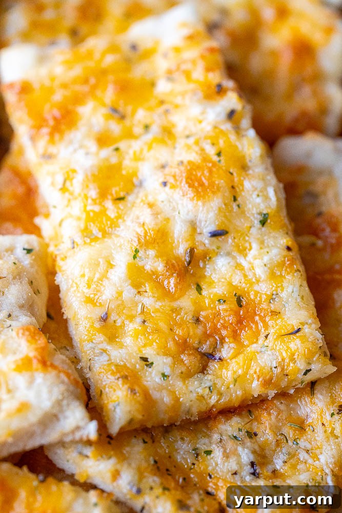 Effortless Garlic Cheese Bread 5 Close up shot of a slice of garlic cheese bread with melted cheese