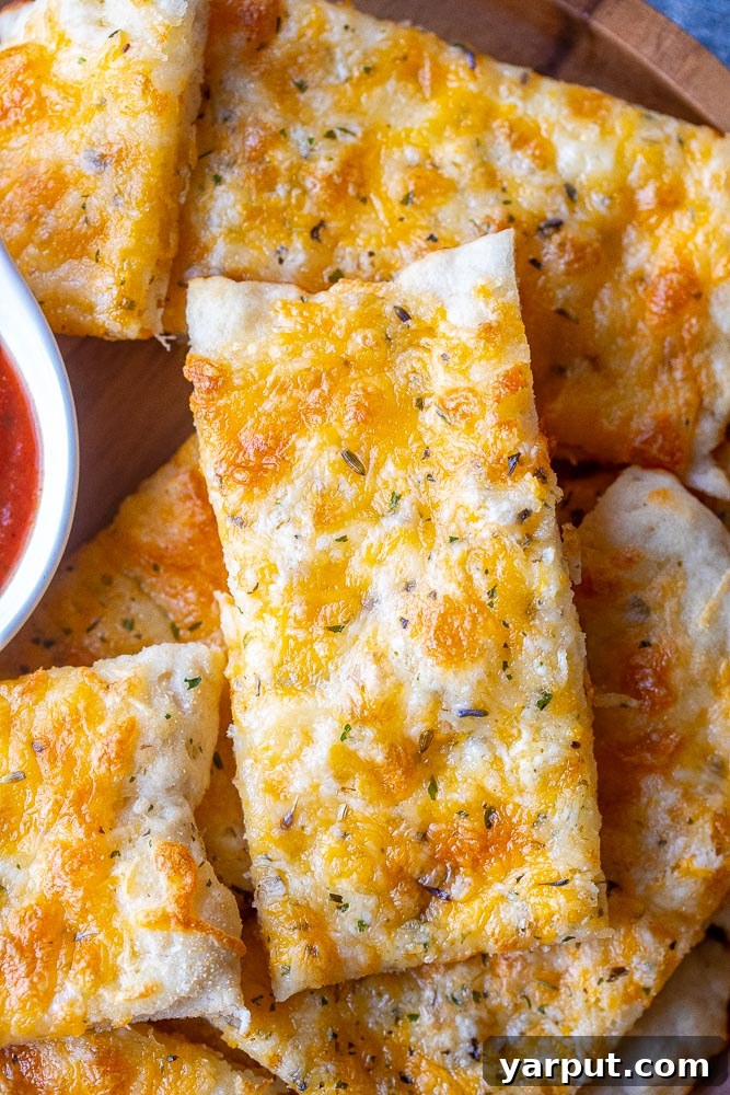 Effortless Garlic Cheese Bread 6 Close-up of a plate of delicious, golden garlic cheese bread ready to be served