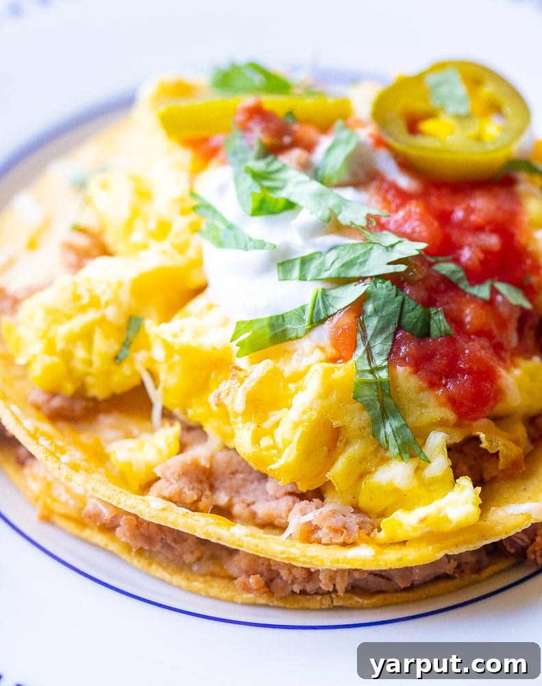 Sunrise Ranchero Stack 4 A close-up view of the perfectly stacked and melted cheese layers in Stacked Huevos Rancheros.