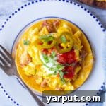 Stacked Huevos Rancheros on a plate.