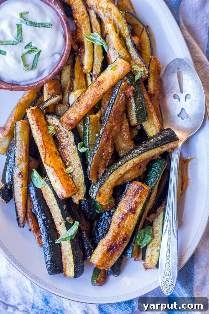 Perfectly Roasted Zucchini 2 A plate of the best roasted zucchini, golden brown and perfectly tender, ready to be enjoyed as a summer side dish or versatile meal component.