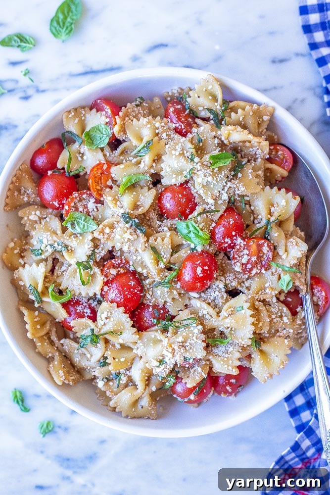 Vibrant Bruschetta Pasta Salad with Parmesan 2 Large bowl of vibrant bruschetta pasta salad, ready to be served