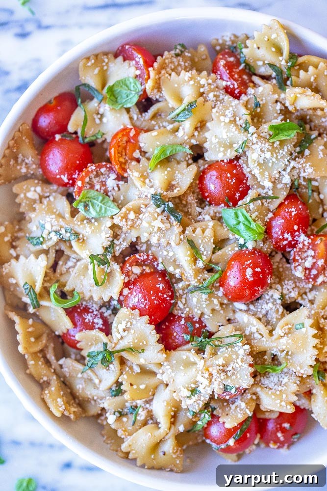 Vibrant Bruschetta Pasta Salad with Parmesan 5 Close-up shot of the finished bruschetta pasta salad in a serving bowl, garnished with fresh basil