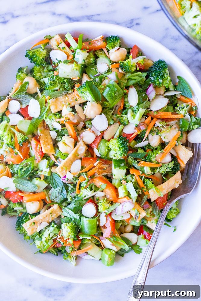 Sesame Ginger Broccoli Crunch 2 Close up of a vibrant bowl of Asian Broccoli Salad with fresh vegetables and a sesame dressing