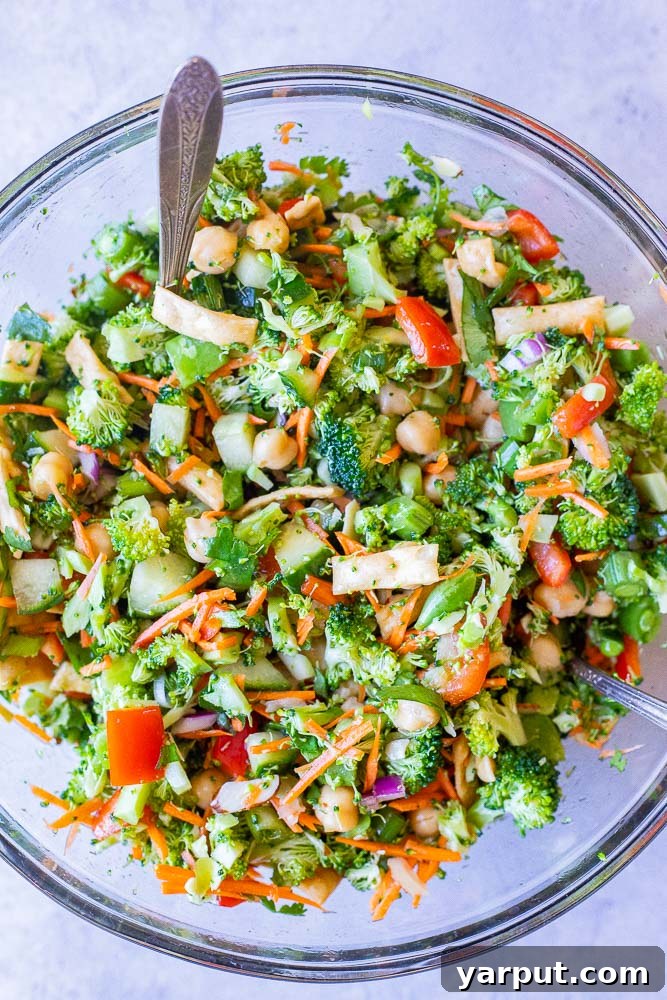 Sesame Ginger Broccoli Crunch 4 A bowl of freshly mixed Asian Broccoli Salad, showcasing the diverse ingredients and dressing