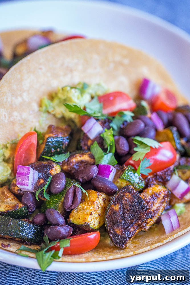 Smoky and Spiced Zucchini Tacos 4 Close up of perfectly blackened and seasoned zucchini pieces inside a corn tortilla