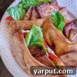 A plate of freshly prepared Vegan BLT Pitas, showcasing their vibrant colors and crispy tofu