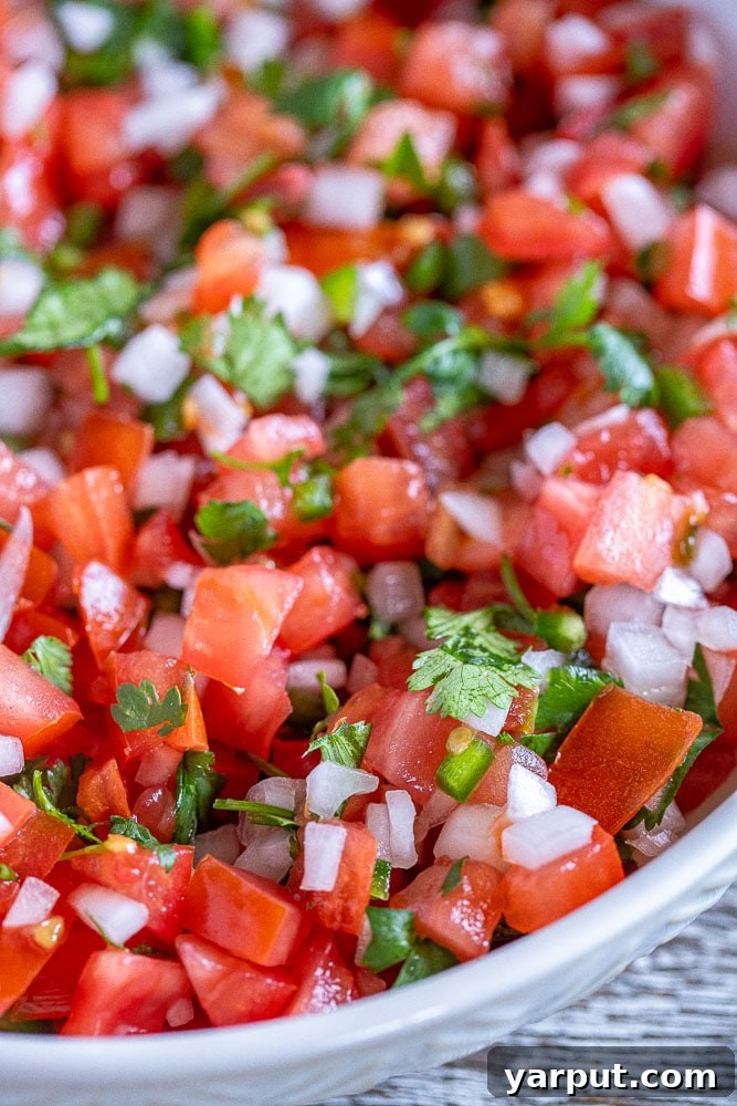 Vibrant Homemade Pico De Gallo 5 A vibrant close-up shot of a bowl of fresh Pico de Gallo, highlighting the finely diced ingredients and their rich colors, ready for dipping.