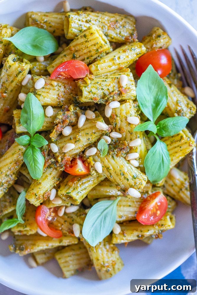 Mediterranean Sun-Dried Tomato Pesto Pasta 4 A close-up view of a serving of Sun-Dried Tomato Pesto Pasta in a bowl, showcasing the rich texture and vibrant colors of the sauce clinging to the pasta.