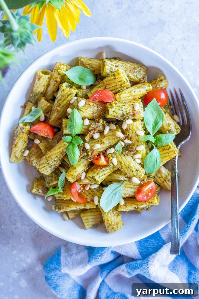 Mediterranean Sun-Dried Tomato Pesto Pasta 6 A generous serving of sun-dried tomato pesto pasta in a ceramic bowl, ready to be enjoyed.