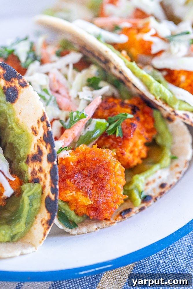 Buffalo Cauliflower Tacos with Creamy Ranch Slaw 5 Close-up side view of fully assembled vegan Buffalo Cauliflower Tacos