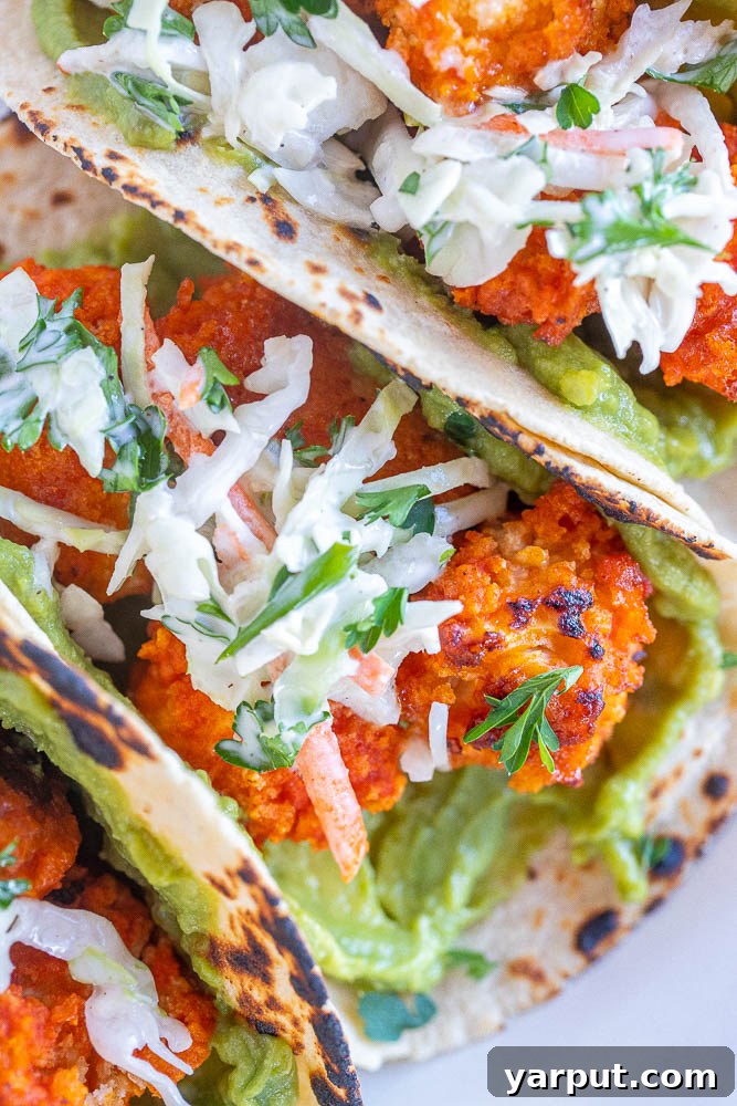 Buffalo Cauliflower Tacos with Creamy Ranch Slaw 6 Close-up of crispy Buffalo Cauliflower with a vibrant orange glaze