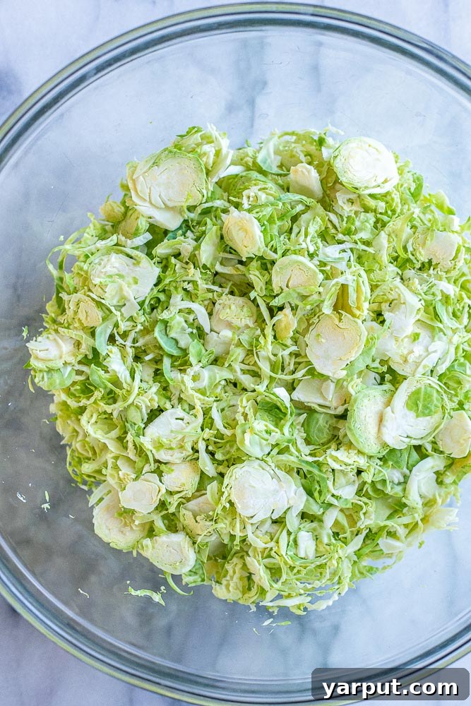 Smoky Charred Brussels Sprouts 3 Shredded brussel sprouts in a bowl with spices