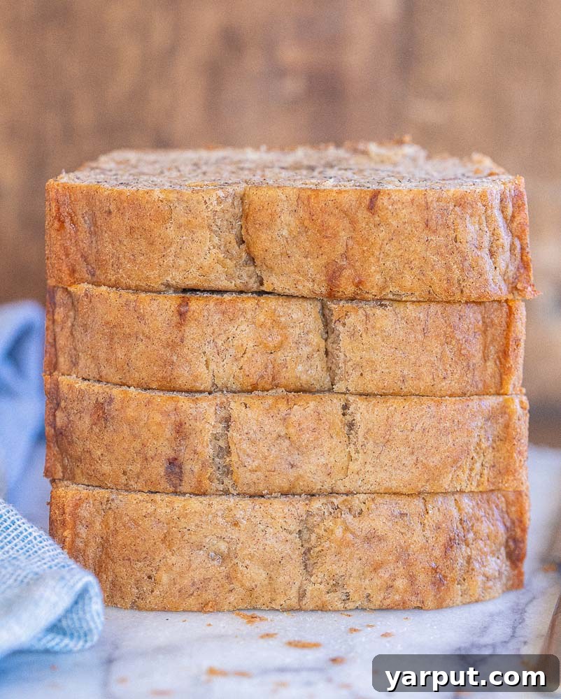 Decadent Vegan Banana Bread 7 Multiple slices of vegan banana bread, perfectly baked and golden, artfully stacked on top of each other.