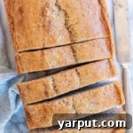 A top-down view of vegan banana bread, showcasing its golden crust and moist texture.
