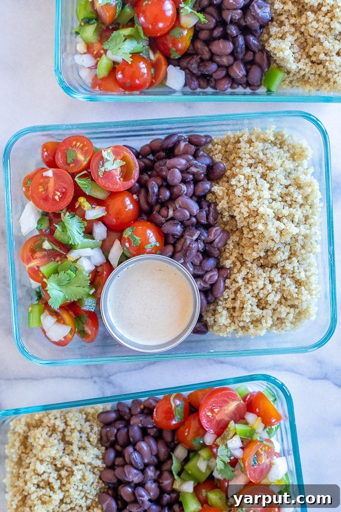 Four perfectly portioned Mexican Quinoa Salad Meal Prep Bowls, arranged in clear containers, showcasing layers of quinoa, black beans, corn, fresh salsa, and a small container of tahini dressing for a week of healthy vegan lunches