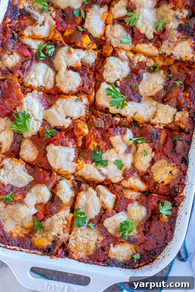 Ultimate Plant-Based Lasagna 7 A close-up shot of a perfectly baked vegan lasagna, fresh from the oven, with its golden-brown top and bubbling sauce, ready to be enjoyed.
