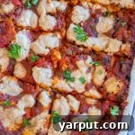 Ultimate Plant-Based Lasagna 8 A vibrant and appetizing close-up of a slice of vegan lasagna, featuring its layered ingredients and a golden-brown top, ready to be served.