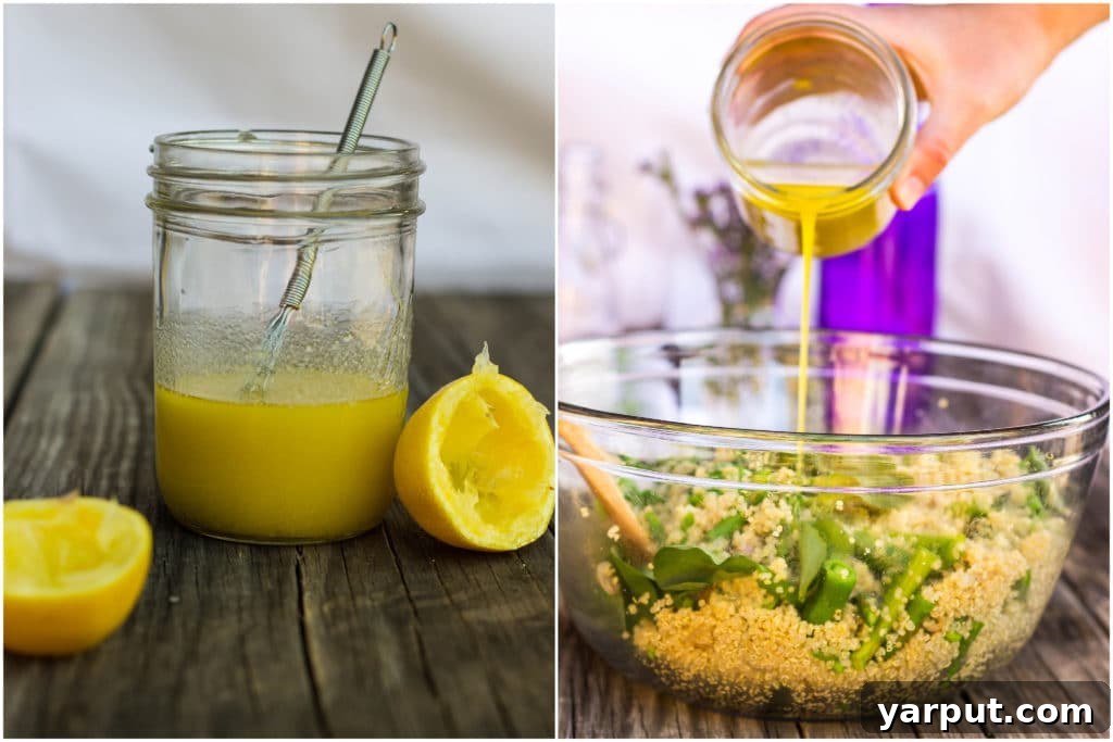 A glass jar filled with vibrant yellow lemon vinaigrette sits next to a large bowl, with the dressing being poured over a freshly mixed spring quinoa salad, highlighting its zesty appeal.