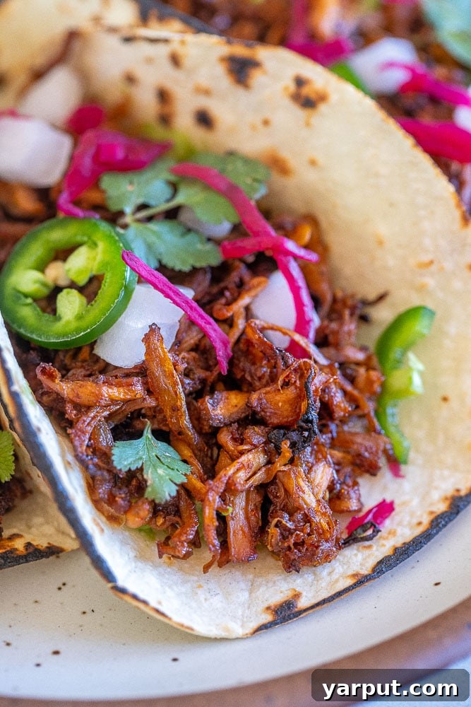 Mushroom Carnitas (Vegan) 6 Close up of a delicious vegan carnitas taco with fresh toppings, showcasing the crispy mushrooms.