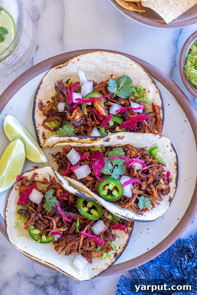 Mushroom Carnitas (Vegan) 7 A vibrant plate of vegan carnitas tacos, garnished and ready to serve.