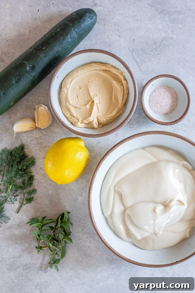 Creamy Vegan Tzatziki Dip 3 A vibrant flat lay showing all the fresh ingredients required to prepare this easy and delicious homemade vegan tzatziki sauce recipe.