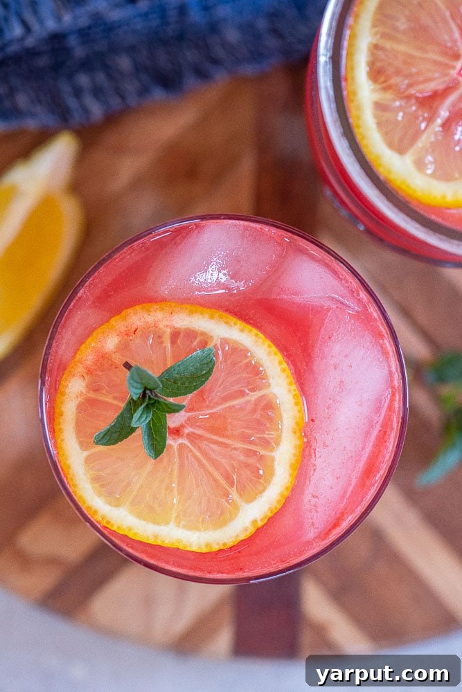 A close-up shot of a glass filled with vibrant pink watermelon lemonade, perfectly chilled and ready to drink.