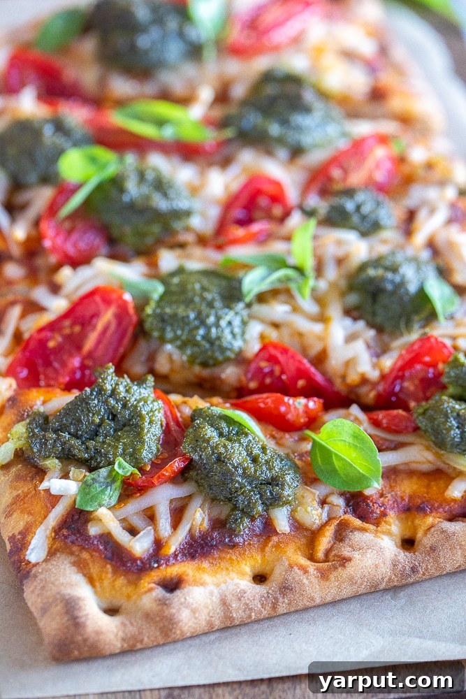 Trader Joe's Simple 5-Ingredient Vegan Tomato Pesto Pizza 6 Another close-up of the vegan tomato pesto pizza, showing the vibrant colors and fresh ingredients