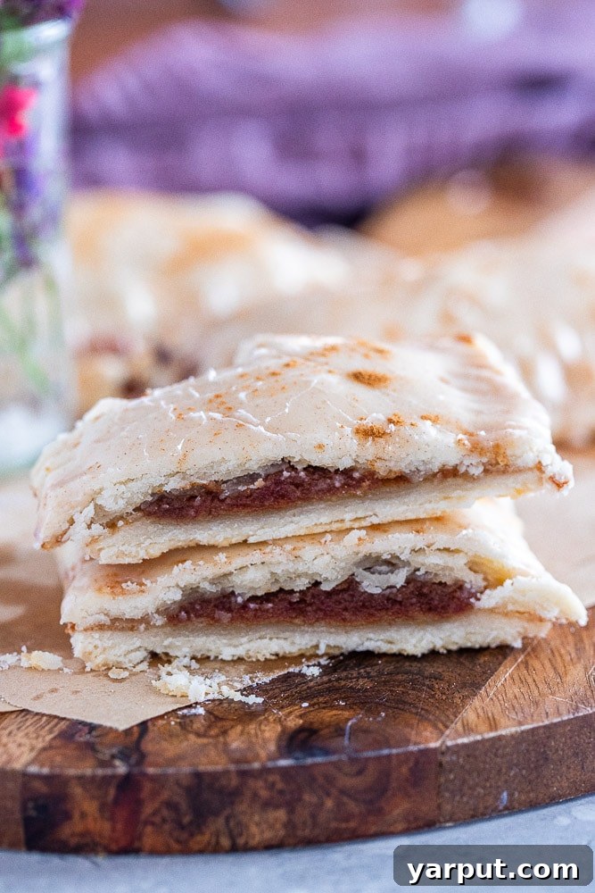 Naturally Sweetened Cinnamon Toaster Delights 5 A cross-section of a homemade cinnamon sugar pop tart, revealing the naturally sweetened date paste filling and flaky crust.