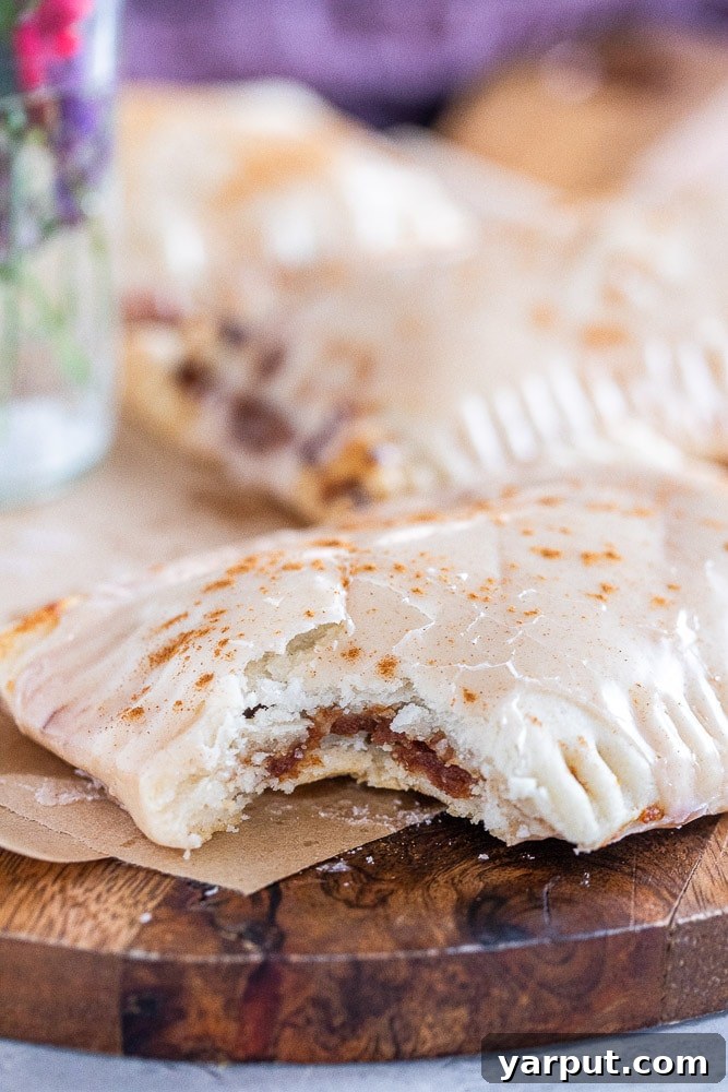 Naturally Sweetened Cinnamon Toaster Delights 7 A homemade cinnamon sugar pop tart with a bite taken out of it, showcasing the rich date paste filling.