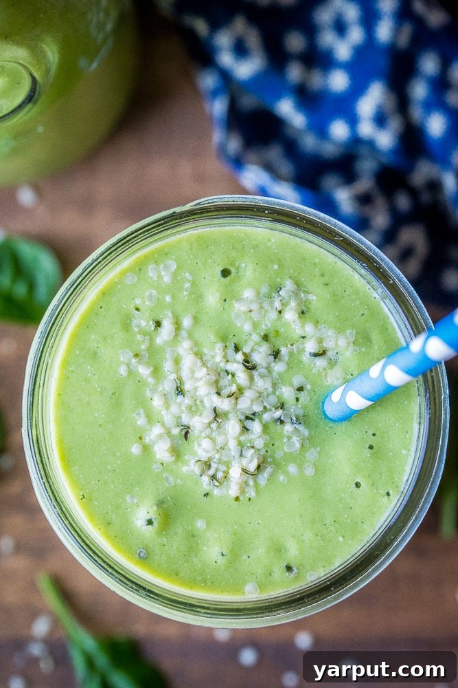 Delicious and Nutritious Green Smoothie for Kids 5 close up of a green smoothie in a cup with hemp hearts on top, ready to drink