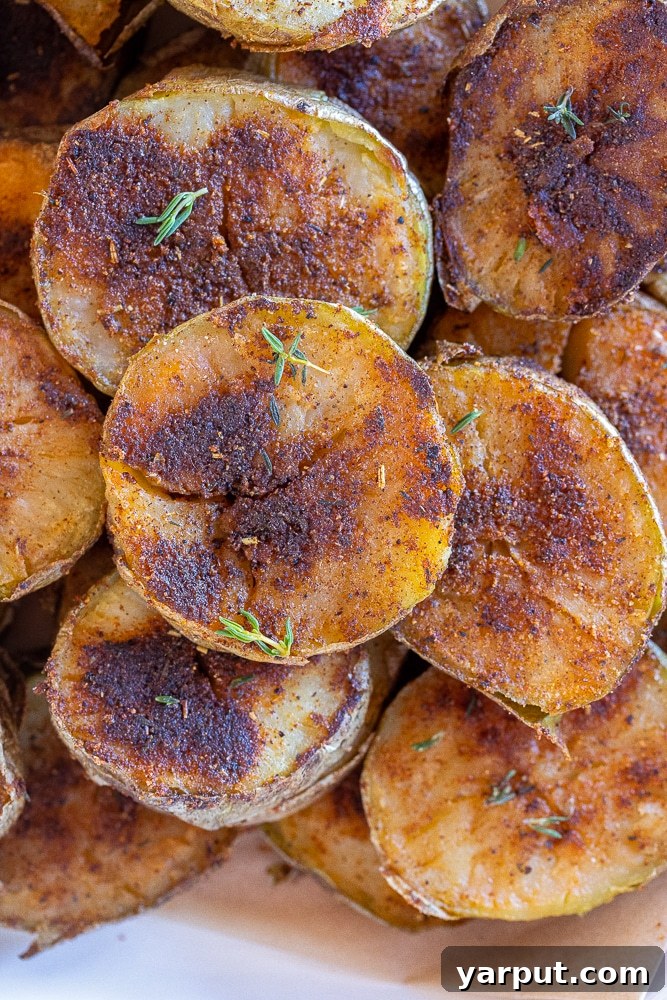 Roasted Blackened Potatoes: A Flavorful Side Dish 6 A close-up shot of a single perfectly roasted blackened potato slice, showcasing its crispy texture and rich seasoning.