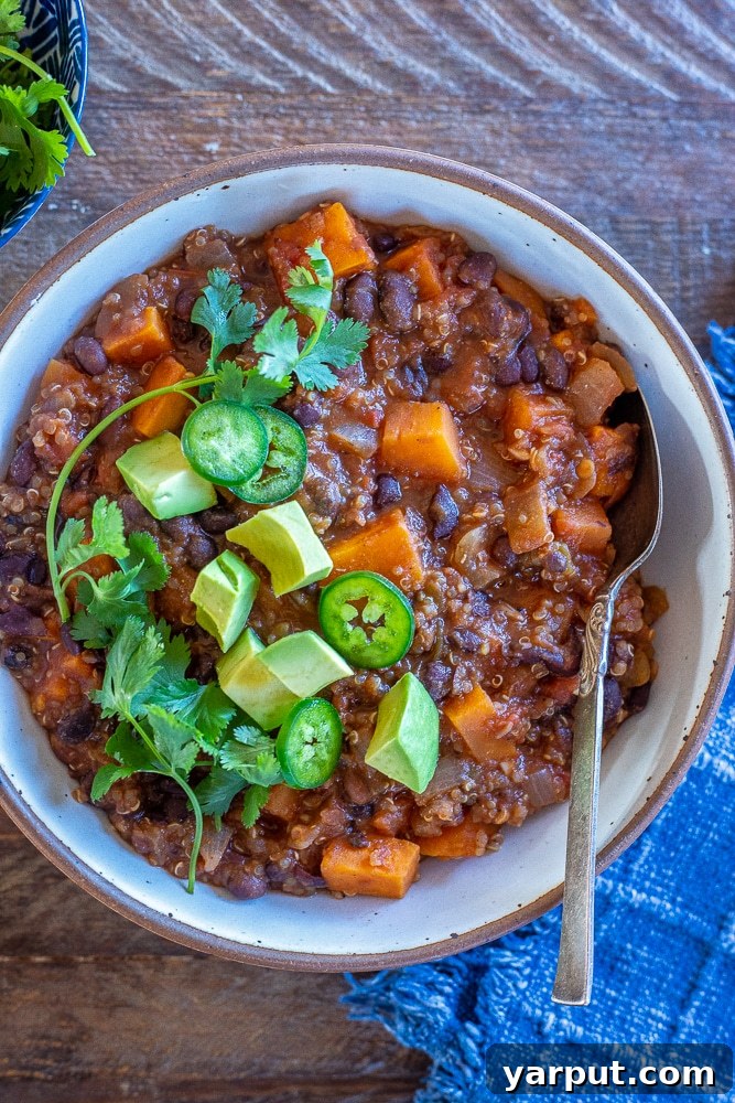 Wholesome Sweet Potato Quinoa Chili 2 Bowl of sweet potato and quinoa chili with garnishes