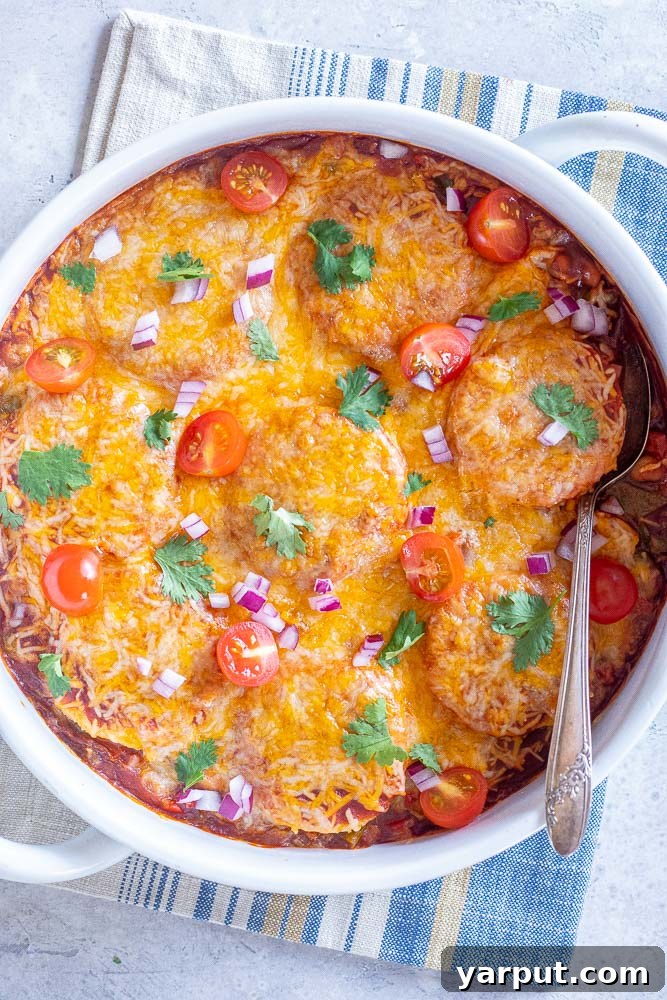 Polenta Enchilada Bake, a creative and comforting casserole featuring polenta and enchilada flavors, topped with cheese.