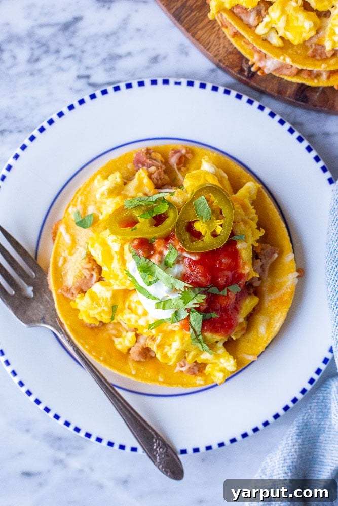 Stacked Huevos Rancheros, a hearty and classic Mexican-inspired breakfast or brunch with layered tortillas and eggs.