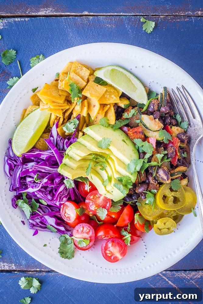 Vegan Taco Bowls, a customizable and healthy deconstructed taco meal, loaded with fresh vegetables and beans.